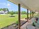 Covered front porch featuring wooden support beams and manicured garden beds in a suburban home at 710 Freeman Dr, Covington, GA 30016
