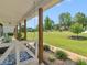 Covered front porch featuring a swing and manicured garden beds in a suburban home at 710 Freeman Dr, Covington, GA 30016
