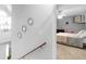 Hallway featuring modern decor and a glimpse into a well-lit bedroom with a ceiling fan at 710 Freeman Dr, Covington, GA 30016