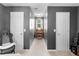 Hallway with a desk, neutral carpet, and doors on either side, leading to various rooms at 710 Freeman Dr, Covington, GA 30016