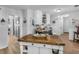Lovely kitchen featuring wood floors, an island, and crisp white cabinetry for a modern, clean space at 710 Freeman Dr, Covington, GA 30016