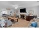 Spacious living room featuring wood-look flooring, neutral decor, and comfortable seating with great natural light at 710 Freeman Dr, Covington, GA 30016