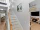 Cozy living room and staircase featuring a fireplace, mantel, and a view of the kitchen at 710 Freeman Dr, Covington, GA 30016