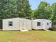 Backyard featuring two storage sheds with double doors and a ramp on a grassy lot at 710 Freeman Dr, Covington, GA 30016