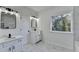 Bright bathroom with double sink vanity, black fixtures, marble floors and lots of natural light from the window at 1285 Cedar Brook Dr, Lawrenceville, GA 30043