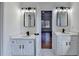 Bathroom boasts double vanities, modern lighting, black faucets, and white cabinets at 1285 Cedar Brook Dr, Lawrenceville, GA 30043