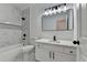 Bathroom with modern vanity, black fixtures, tub and shower with marble-look tile at 1285 Cedar Brook Dr, Lawrenceville, GA 30043