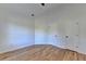 Corner bedroom with wood flooring, white walls, and two white doors with black handles at 1285 Cedar Brook Dr, Lawrenceville, GA 30043