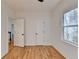 A bright bedroom with wood floors, white walls, a large window and two doors at 1285 Cedar Brook Dr, Lawrenceville, GA 30043