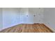 Bright bedroom with wood flooring, white walls and two doors at 1285 Cedar Brook Dr, Lawrenceville, GA 30043