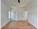 Bedroom boasts hardwood floors, tray ceiling, and views of ensuite at 1285 Cedar Brook Dr, Lawrenceville, GA 30043