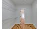 A simple walk-in closet space with open wire shelving units and wood flooring at 1285 Cedar Brook Dr, Lawrenceville, GA 30043