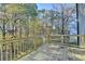 Exterior shot of backyard wooden deck overlooking wooded area at 1285 Cedar Brook Dr, Lawrenceville, GA 30043