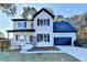 Charming two-story home with white brick, black shutters, an attached garage and a landscaped front yard at 1285 Cedar Brook Dr, Lawrenceville, GA 30043