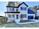 Charming two-story home with white brick, black shutters, an attached garage and a landscaped front yard at 1285 Cedar Brook Dr, Lawrenceville, GA 30043