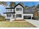 Charming two-story home with white brick, black shutters, an attached garage and a landscaped front yard at 1285 Cedar Brook Dr, Lawrenceville, GA 30043