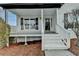 Inviting front porch with white brick, white railings, freshly painted steps, and a stylish front door at 1285 Cedar Brook Dr, Lawrenceville, GA 30043