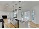 Beautiful kitchen with white cabinets, marble countertops, a center island, and modern pendant lighting at 1285 Cedar Brook Dr, Lawrenceville, GA 30043