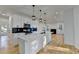 Contemporary kitchen with a large island, white countertops, and modern lighting, flowing into an open floor plan at 1285 Cedar Brook Dr, Lawrenceville, GA 30043