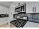 Updated kitchen showcases stainless steel appliances, marble backsplash, and modern design at 1285 Cedar Brook Dr, Lawrenceville, GA 30043