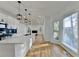Open concept kitchen with stainless steel appliances, white cabinets, and hardwood floors, perfect for entertaining at 1285 Cedar Brook Dr, Lawrenceville, GA 30043