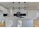 Spacious kitchen with a large center island, modern light fixtures, stainless steel appliances, and plenty of counter space at 1285 Cedar Brook Dr, Lawrenceville, GA 30043