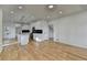 Well-lit kitchen with an island, black backsplash, white cabinetry, modern appliances, and wood floors at 1285 Cedar Brook Dr, Lawrenceville, GA 30043