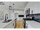 Close up of a kitchen with white cabinets, black hardware, quartz countertops, and stainless steel appliances at 1285 Cedar Brook Dr, Lawrenceville, GA 30043