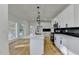 Updated kitchen with white cabinetry, stainless steel appliances, and a large island with quartz countertops at 1285 Cedar Brook Dr, Lawrenceville, GA 30043