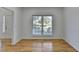 Bright living room features natural light through a large window, and newly refinished hardwood floors at 1285 Cedar Brook Dr, Lawrenceville, GA 30043