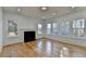 This living room boasts hardwood floors, centered by a fireplace and surrounded by natural light streaming through multiple windows at 1285 Cedar Brook Dr, Lawrenceville, GA 30043