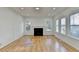 Spacious living area with hardwood floors, fireplace and multiple windows flooding the space with natural light at 1285 Cedar Brook Dr, Lawrenceville, GA 30043