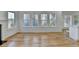 Open-concept living room boasts hardwood floors, natural light from the windows, and view to the kitchen bar at 1285 Cedar Brook Dr, Lawrenceville, GA 30043