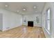 Bright living room with a classic fireplace, hardwood floors, and abundant windows for ample natural light at 1285 Cedar Brook Dr, Lawrenceville, GA 30043