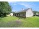 Spacious backyard with green grass, a house with light siding, and surrounded by lush trees at 1290 Silverstone Trl, Jonesboro, GA 30238