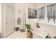 Bright bathroom featuring a soaking tub under a window with stylish privacy sheers and modern fixtures at 1290 Silverstone Trl, Jonesboro, GA 30238