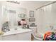 Bright bathroom with a single vanity, toilet, and shower/tub combination with framed artwork on the wall at 1290 Silverstone Trl, Jonesboro, GA 30238