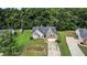 Charming home featuring a well-maintained lawn, brick facade, and bay window, set against a backdrop of lush trees at 1290 Silverstone Trl, Jonesboro, GA 30238
