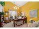 Inviting home office bathed in sunlight, featuring a chandelier, a desk, and comfortable seating at 1290 Silverstone Trl, Jonesboro, GA 30238