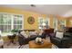 Bright living room with dual windows, dark leather furniture, and a cozy seating arrangement at 1290 Silverstone Trl, Jonesboro, GA 30238