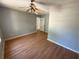 Bedroom with wood floors, ceiling fan, and natural light is ready for your personal touches at 2715 Cordite Loop, Snellville, GA 30039