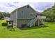 The backyard view shows a small deck with stairs at 4090 Mark Todd Ct, Hoschton, GA 30548