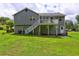 Exterior backyard view with deck, stairs, and patio at 4090 Mark Todd Ct, Hoschton, GA 30548