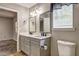 This bathroom includes a double sink vanity with mirrors and a window at 4090 Mark Todd Ct, Hoschton, GA 30548