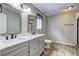 A bathroom featuring a double sink vanity, wood-look flooring, and neutral paint at 4090 Mark Todd Ct, Hoschton, GA 30548