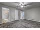 Large bedroom with new carpeting, ceiling fan and multiple doorways at 4090 Mark Todd Ct, Hoschton, GA 30548