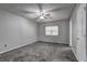 Comfortable bedroom with new carpeting, a ceiling fan, and a double door closet at 4090 Mark Todd Ct, Hoschton, GA 30548