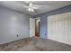 Carpeted bedroom featuring closet and ceiling fan at 4090 Mark Todd Ct, Hoschton, GA 30548