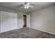A carpeted bedroom with closet and ceiling fan at 4090 Mark Todd Ct, Hoschton, GA 30548