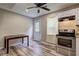 The eat-in kitchen features stainless steel appliances, wood look floors, and neutral walls at 4090 Mark Todd Ct, Hoschton, GA 30548